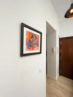 a picture hanging on a wall in a room at La Casa de Lima Little Apartments in Cádiz