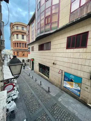 an empty street in a city with a building at Estudio Las Flores by Cadiz Time in Cádiz