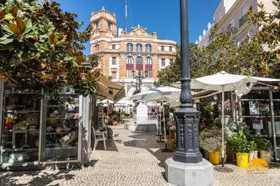 a street with umbrellas and a building in the background at Estudio Las Flores by Cadiz Time in Cádiz