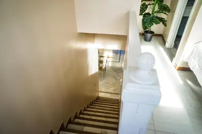 a staircase in a house with a stair case at Atico BLUE Beach in El Puerto de Santa María