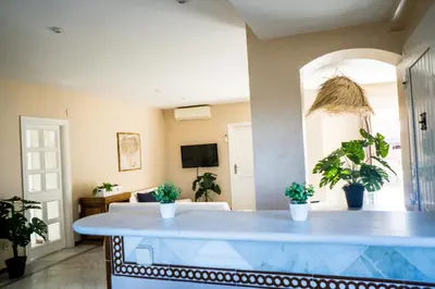 a living room with a table and potted plants at Atico BLUE Beach in El Puerto de Santa María