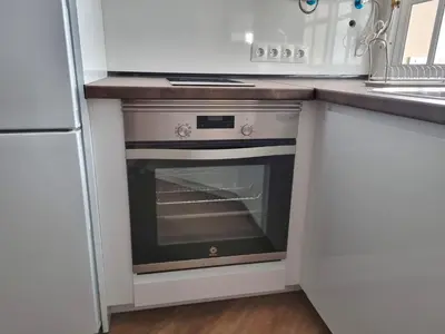 a kitchen with an oven in a white kitchen at Aujada playa in Cádiz
