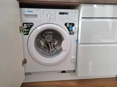 a white washing machine sitting next to a washer at Aujada playa in Cádiz