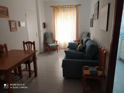 a living room with a couch and a table at ALQUILER CHIPIONA in Chipiona
