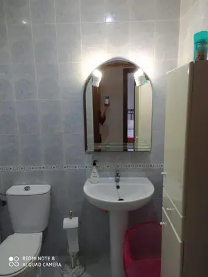 a bathroom with a sink and a toilet and a mirror at ALQUILER CHIPIONA in Chipiona