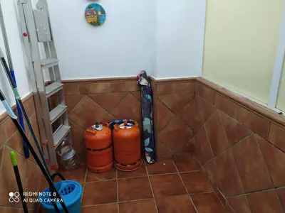 two orange cylinders sitting on the floor in a bathroom at ALQUILER CHIPIONA in Chipiona
