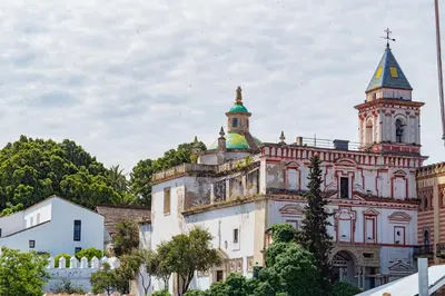 an old building with a tower and a turret at Piso San Roque in Sanlúcar de Barrameda