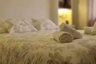 a bed with a pile of towels on it at Ático Reig frente al mar in Sanlúcar de Barrameda