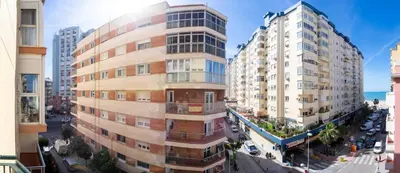 a tall building next to two tall buildings at Brasil Playa Ha Apartment in Cádiz
