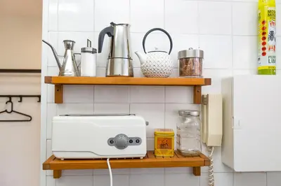 a white toaster on a shelf in a kitchen at Mirador del Guadalquivir in Sanlúcar de Barrameda