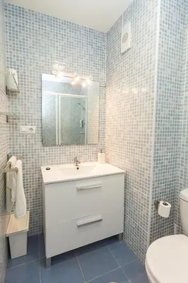 a bathroom with a sink and a toilet and a mirror at Mirador del Guadalquivir in Sanlúcar de Barrameda