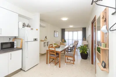 a kitchen and dining room with a table and chairs at Mirador del Guadalquivir in Sanlúcar de Barrameda