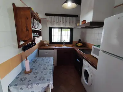 a small kitchen with a sink and a refrigerator at El Cortijo de Pepa in Conil de la Frontera