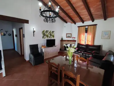 a living room with a table and a couch at El Cortijo de Pepa in Conil de la Frontera