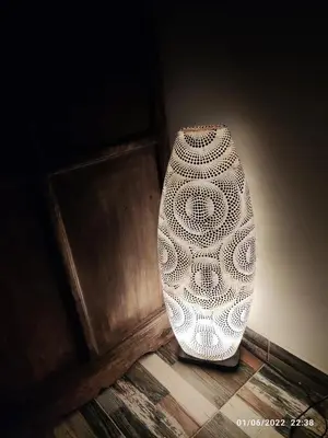 a white vase sitting on a floor next to a wall at Villa Bali con jacuzzi climatizado y piscina climatizada con jacuzzi in Chiclana de la Frontera