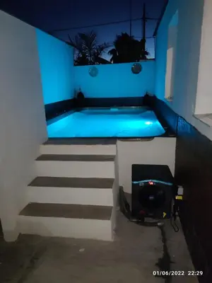 a swimming pool with blue lighting in a room at Villa Bali con jacuzzi climatizado y piscina climatizada con jacuzzi in Chiclana de la Frontera