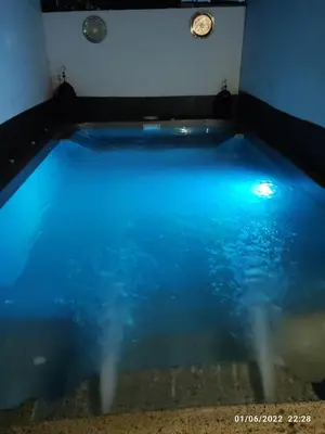 a pool of blue water in a room at Villa Bali con jacuzzi climatizado y piscina climatizada con jacuzzi in Chiclana de la Frontera