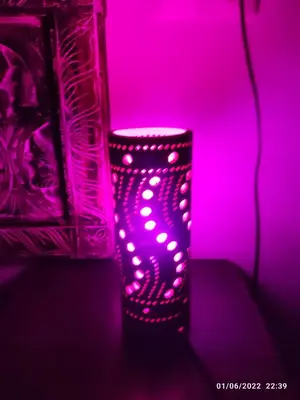 a pink candle holder sitting next to a vase at Villa Bali con jacuzzi climatizado y piscina climatizada con jacuzzi in Chiclana de la Frontera