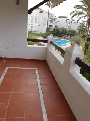 a balcony of a building with a swimming pool at Luceros in Rota