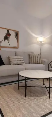a living room with a white couch and a coffee table at el 2 de Flamenco 1ºB in Cádiz