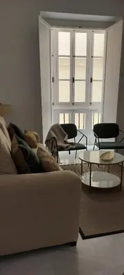 a living room with a couch and two tables at el 2 de Flamenco 2ºB in Cádiz