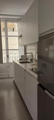a kitchen with white cabinets and a stove at el 2 de Flamenco 2ºB in Cádiz