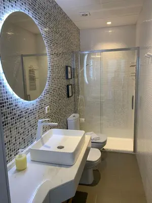 a bathroom with a sink and a toilet and a mirror at el 2 de Flamenco 2ºB in Cádiz