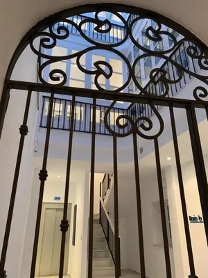 an iron gate with a staircase in a building at el 2 de Flamenco 2ºB in Cádiz