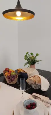 a table with a plate of bread and a basket of fruit at el 2 de Flamenco 2ºB in Cádiz