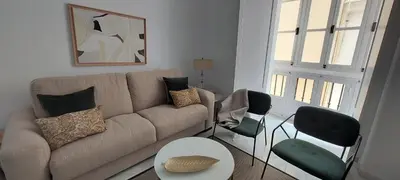 a living room with a couch and two chairs at el 2 de Flamenco 2ºB in Cádiz