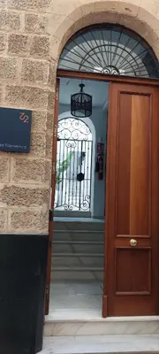 an entrance to a building with a wooden door at el 2 de Flamenco 1ºA in Cádiz