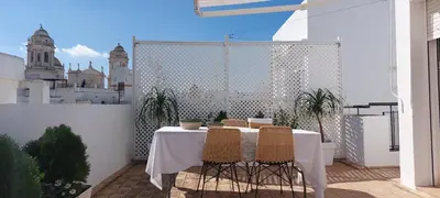 a white table and chairs on a balcony at el 2 de Flamenco Ático 3ºB in Cádiz