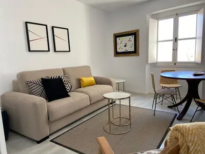 a living room with a couch and a table at el 2 de Flamenco Ático 3ºB in Cádiz