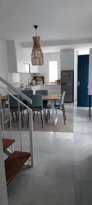 a kitchen and dining room with a table and chairs at El 2 de Flamenco Ático 3ºA in Cádiz