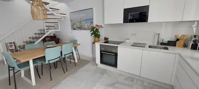 a kitchen and dining room with a table and chairs at El 2 de Flamenco Ático 3ºA in Cádiz