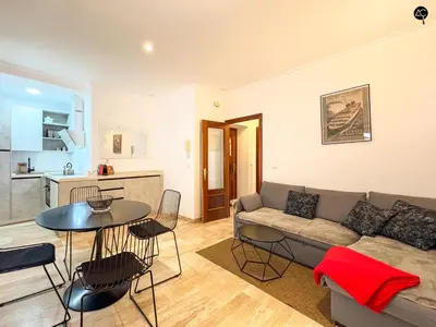 a living room with a couch and a table at Dolce Vita en la Caleta Grupo AC Gestion in Cádiz