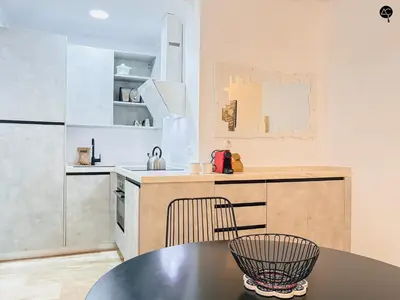 a kitchen with a table and a counter top at Dolce Vita en la Caleta Grupo AC Gestion in Cádiz