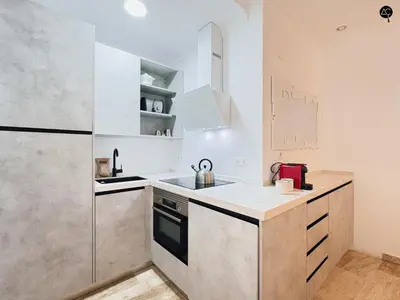 a kitchen with a sink and a refrigerator at Dolce Vita en la Caleta Grupo AC Gestion in Cádiz