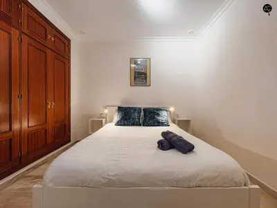 a bedroom with a white bed with two pillows at Dolce Vita en la Caleta Grupo AC Gestion in Cádiz