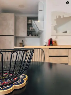 a kitchen with a black table with a chair on it at Dolce Vita en la Caleta Grupo AC Gestion in Cádiz