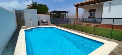 a swimming pool in the backyard of a house at Chalet Hercules la barrosa in Chiclana de la Frontera