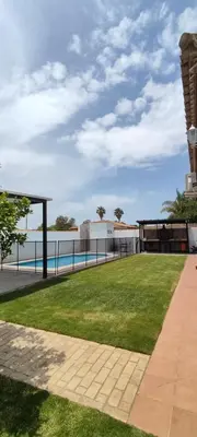 a park with a grassy field and a fence at Chalet Hercules la barrosa in Chiclana de la Frontera