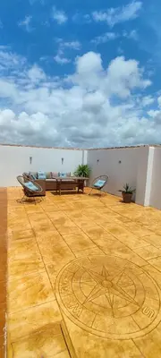 a living room with a couch and chairs on a wooden floor at Chalet Hercules la barrosa in Chiclana de la Frontera