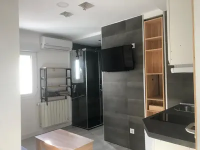 a small kitchen with a refrigerator and a sink at Torredelfino in Jerez de la Frontera