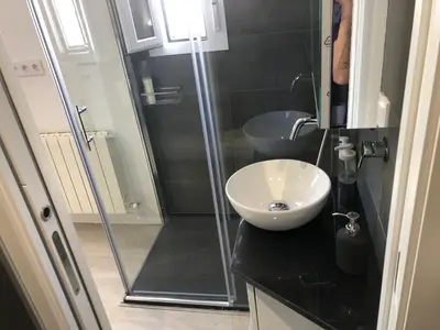 a bathroom with a sink and a glass shower at Torredelfino in Jerez de la Frontera