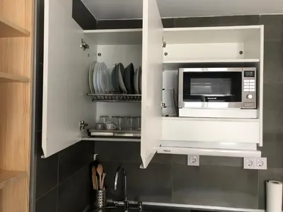 a kitchen with a microwave above a sink at Torredelfino in Jerez de la Frontera