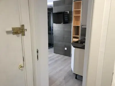 a room with a kitchen with a sink and a door at Torredelfino in Jerez de la Frontera