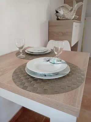 a table with two plates and wine glasses on it at El Vaivén in El Puerto de Santa María