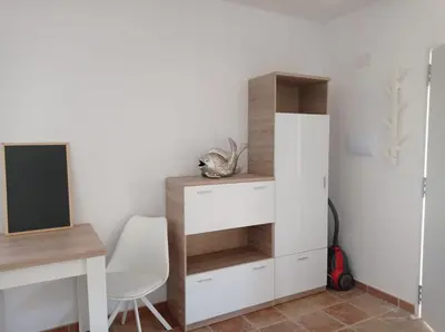 a room with a desk and a white cabinet at El Vaivén in El Puerto de Santa María