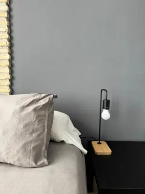 a bed with a pillow and a lamp on a table at Aires de Regla, Apartamentos Living Sur in Chipiona